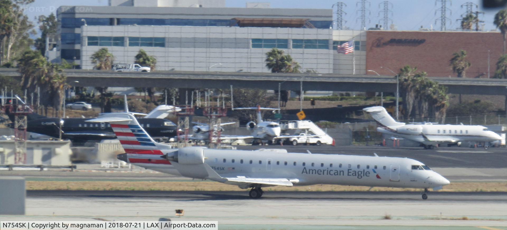 N754SK, 2005 Bombardier CRJ-701 (CL-600-2C10) Regional Jet C/N 10215, braking to see the biz jets!