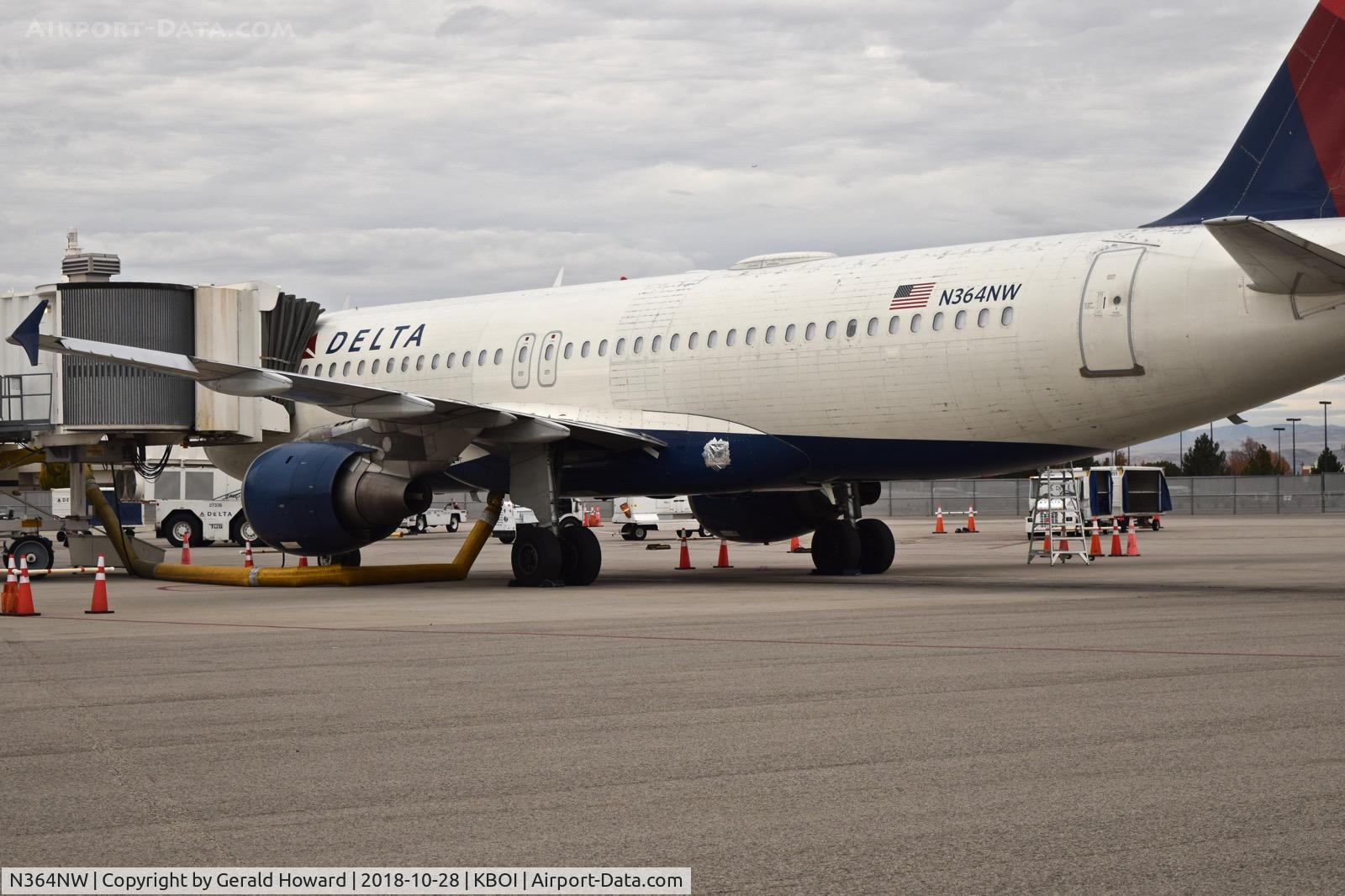 N364NW, 1999 Airbus A320-212 C/N 0962, Parked at the gate. Looks like some repairs to the lower body.