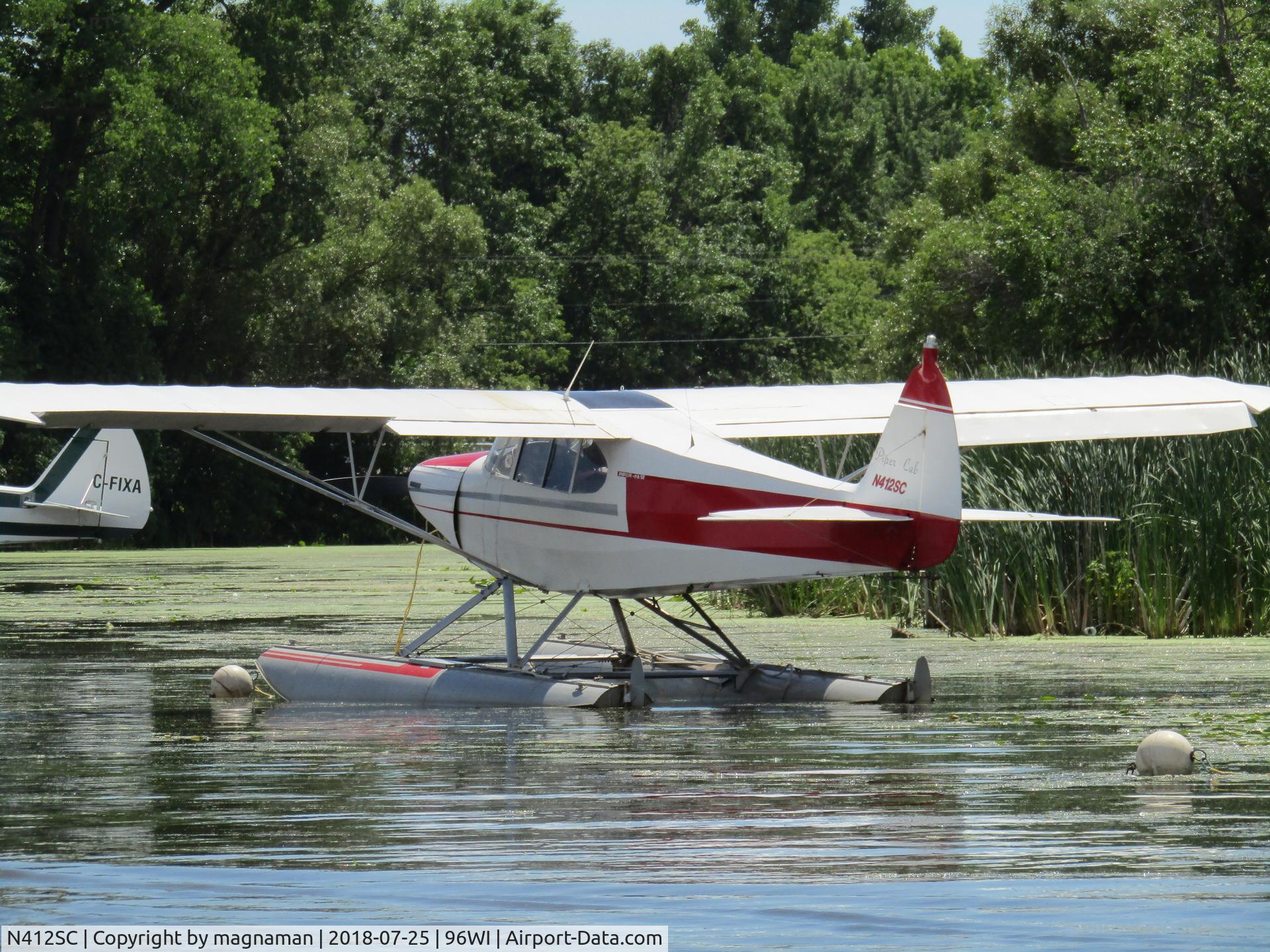 N412SC, 1946 Piper PA-12 Super Cruiser C/N 12-868, on lake at OSH