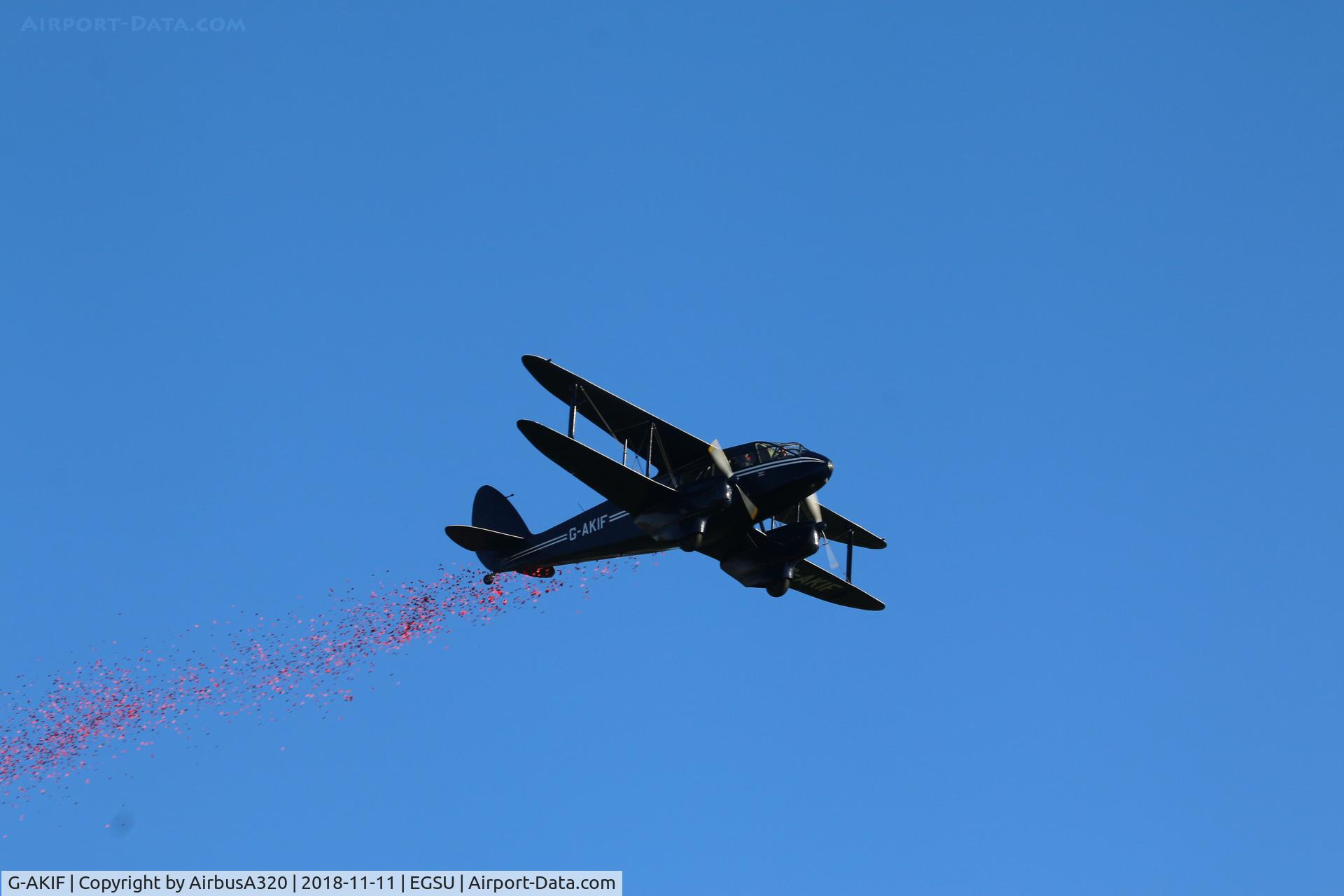G-AKIF, 1944 De Havilland DH-89A Dominie/Dragon Rapide C/N 6838, Performing a fly past dropping Poppies during remembrance sunday at Duxford