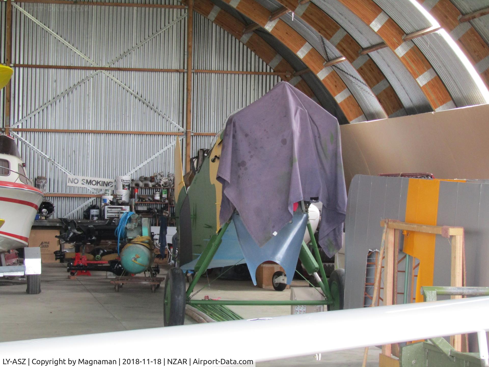 LY-ASZ, Polikarpov Po-2 C/N Not found LY-ASZ, Think this is the ex LY-ASZ noted first some five years ago! - same colour to front legs but uselage has been updated - still not fully assembled. Multi-coloured wings were stored in side of hangar.