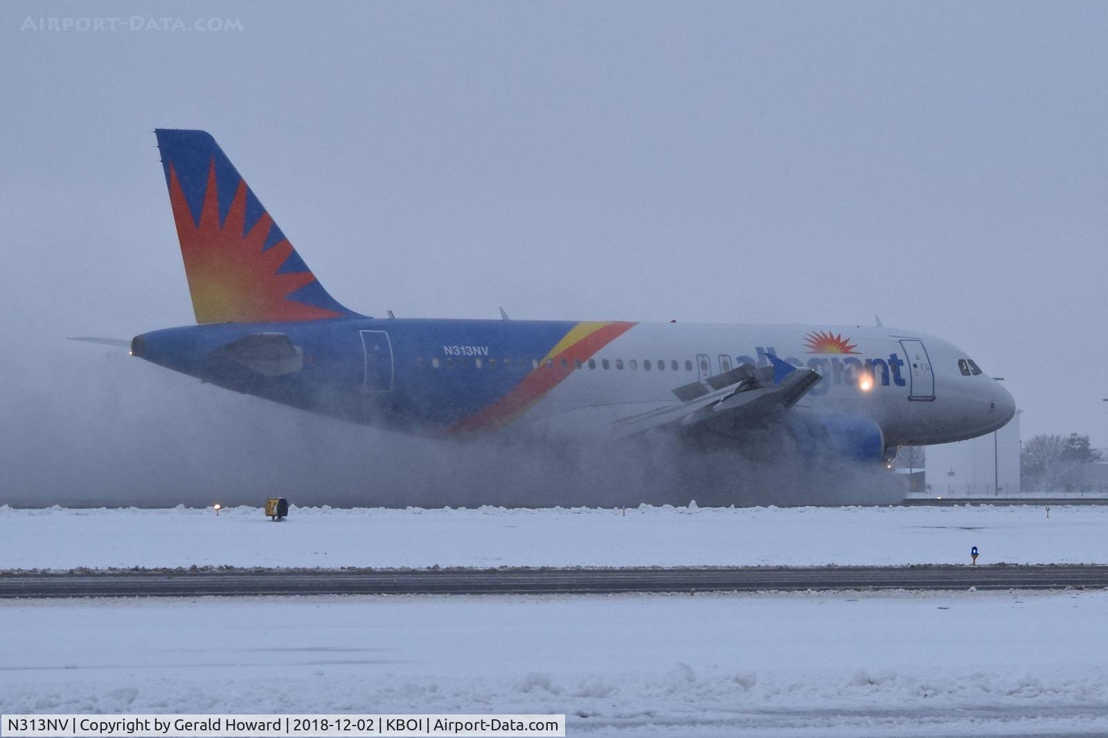 N313NV, 2004 Airbus A319-111 C/N 2300, Landing roll out thru the slush.