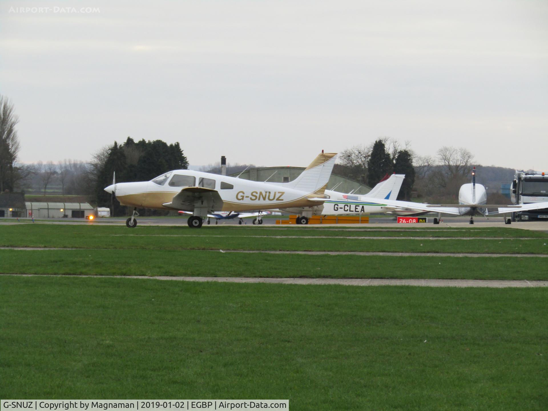 G-SNUZ, 1983 Piper PA-28-161 Cherokee Warrior II C/N 28-8416021, along with G-CLEA at flying club apron - Cotswold Airport - aka Kemble