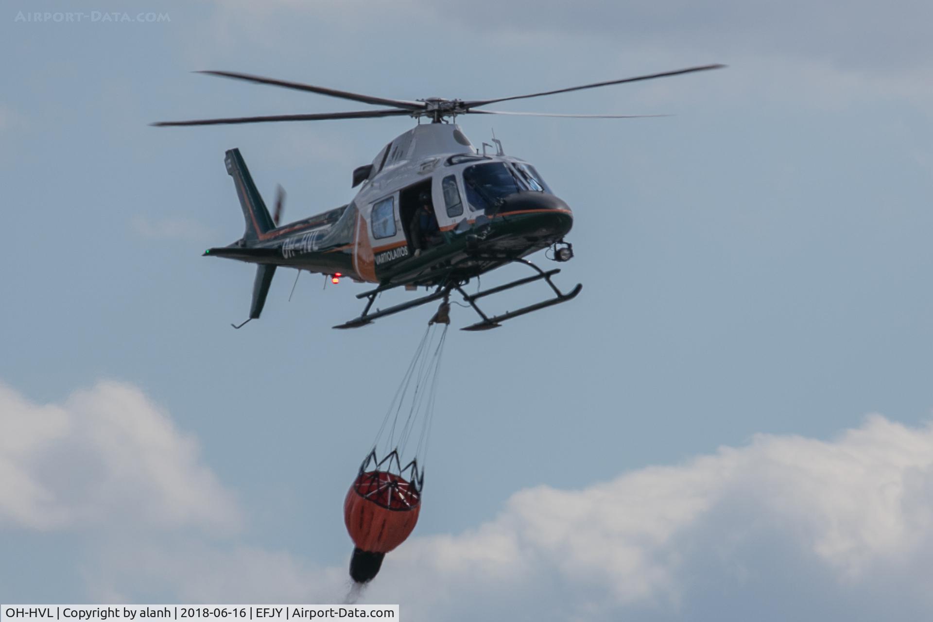 OH-HVL, AgustaWestland AW-119Ke Koala C/N 14733, Performing a water drop at the Finnish Air Force 100th Anniversary air show