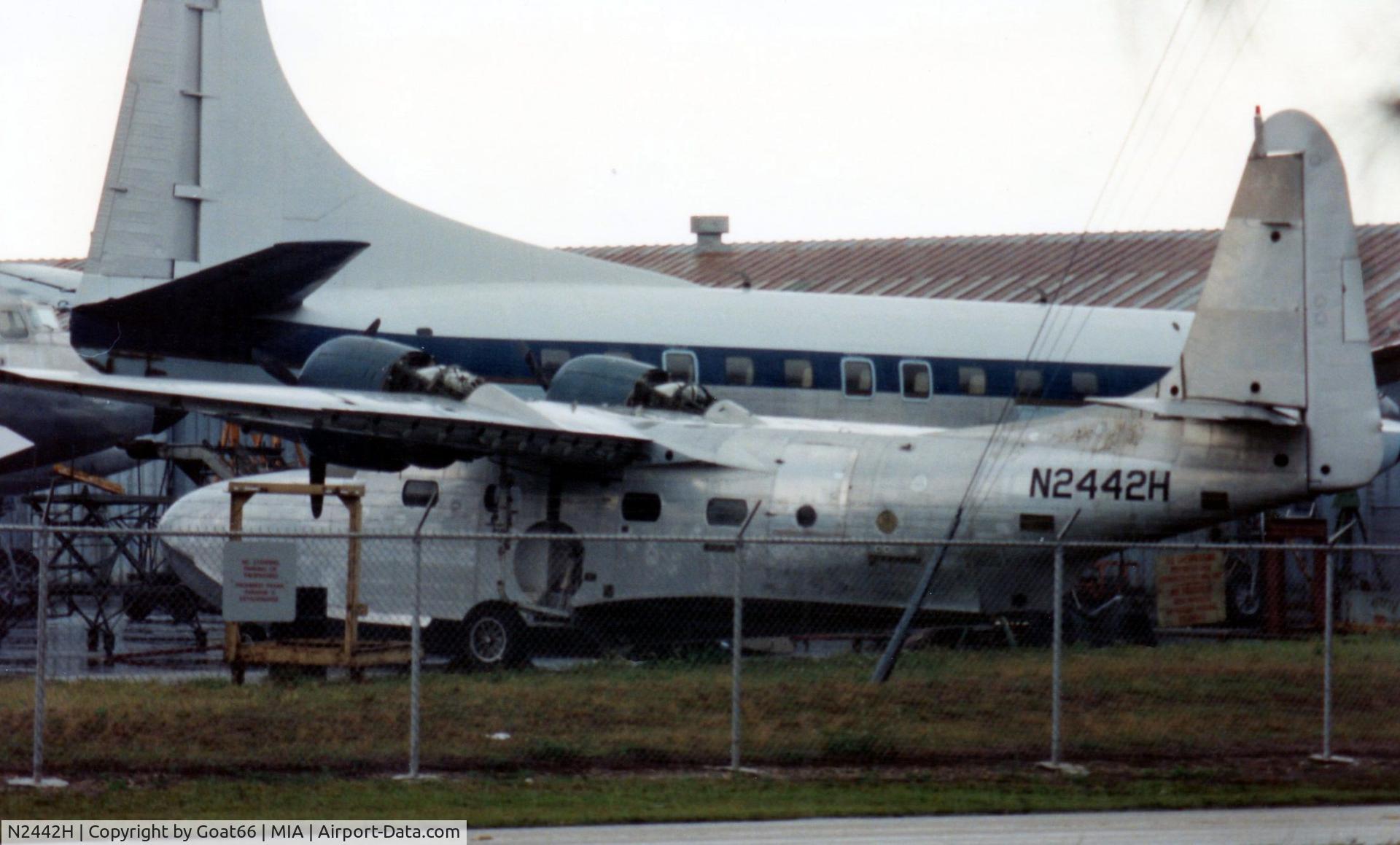 N2442H, 1947 Grumman G-73 Mallard Mallard C/N J-13, With a fascinating range of previous owners, N442H sits minus control surfaces, fairings, and many other parts at MIA in March 1990.  Later superbly restored, find her on this site, at N2950 to see just what TLC and lots of $$$ can achieve.