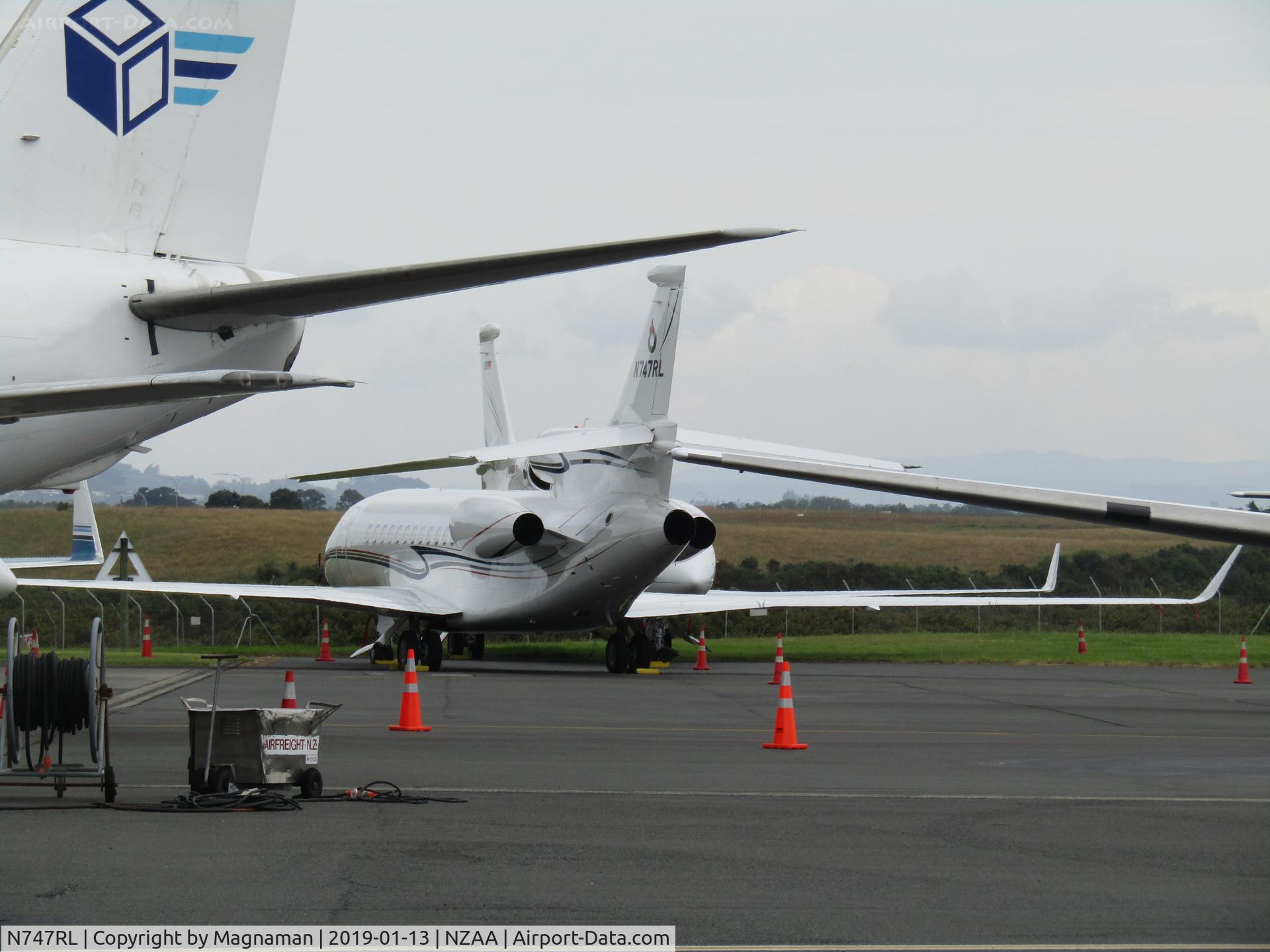 N747RL, 2011 Dassault Falcon 7X C/N 158, with D-ASSY in background
