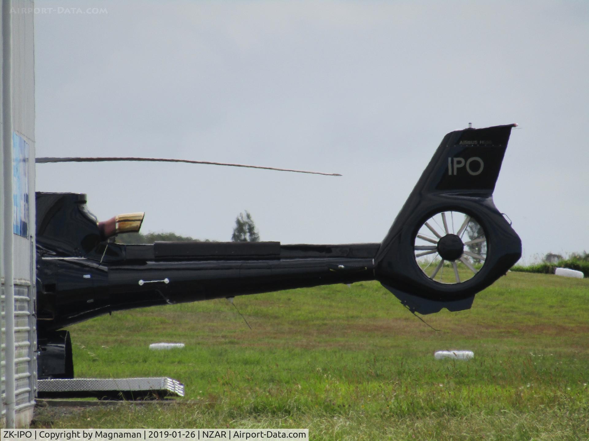 ZK-IPO, Eurocopter EC-130T-2 C/N 8486, poking out behind hangar
