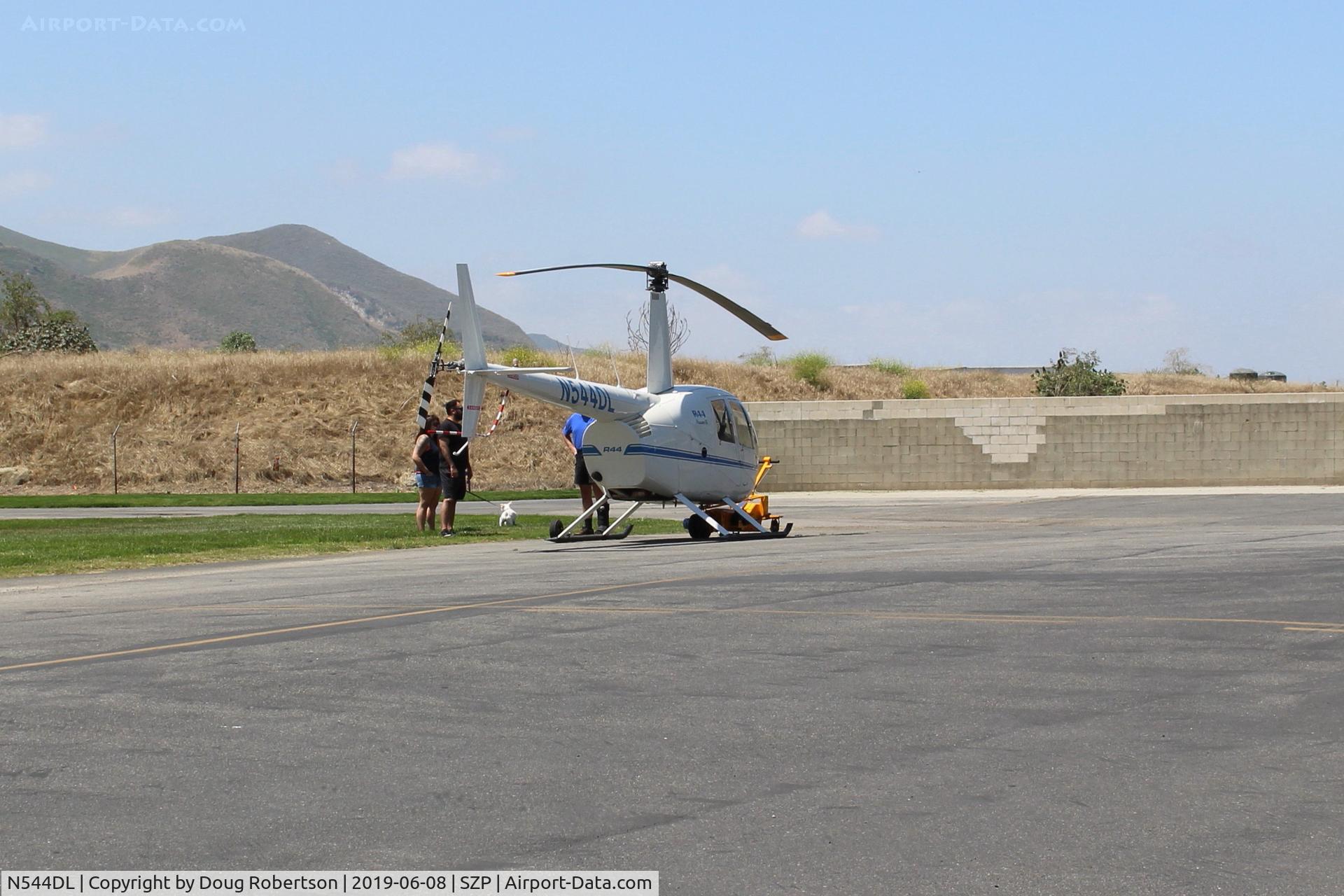 N544DL, 2005 Robinson R44 Raven II C/N 10783, 2005 Robinson R44 RAVEN II, Lycoming IO-540-AE1A5 260 Hp de-rated to 225 Hp for takeoff, 205 Hp continuous, owner chatting with interested onlookers after landing near it's hangar.
