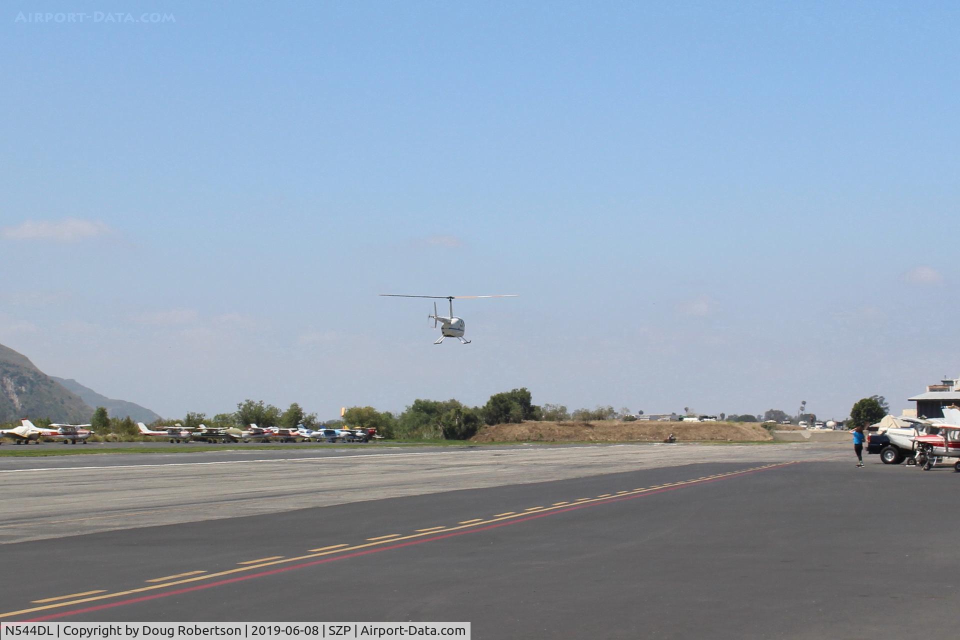 N544DL, 2005 Robinson R44 Raven II C/N 10783, 2005 Robinson R44 RAVEN II, Lycoming IO-540-AE1A5 260 Hp de-rated to 225 Hp for takeoff, 205 Hp continuous, approaching to land near it's hangar.