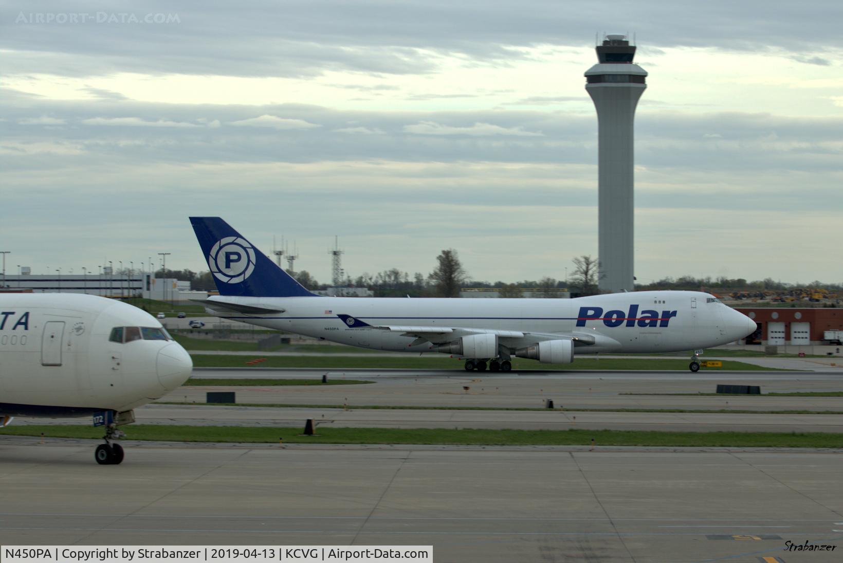 N450PA, 2000 Boeing 747-46NF C/N 30808, Boeing 747-400F of Polar Air Cargo taking off as flight PO958 for Anchorage, Tokyo & Shanghai.
Note the Krueger flaps deployed on the leading edge.
At left 767-332(ER) N172DN begins to taxi out for flight DL228 to
Paris