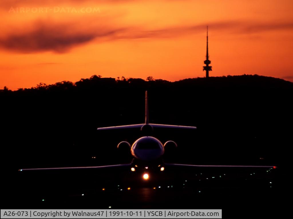 A26-073, 1989 Dassault Falcon 900 C/N 073, Low res ‘silhouette’ photo of 34 Squadron VIP Falcon 900 A26-073 Cn 073 taxying in (with Lights On) from Canberra's Rwy 35 after sunset on 11Oct1991. (Telstra Tower on Black Mountain is visible at rear, matching the F900 tail fin.)
