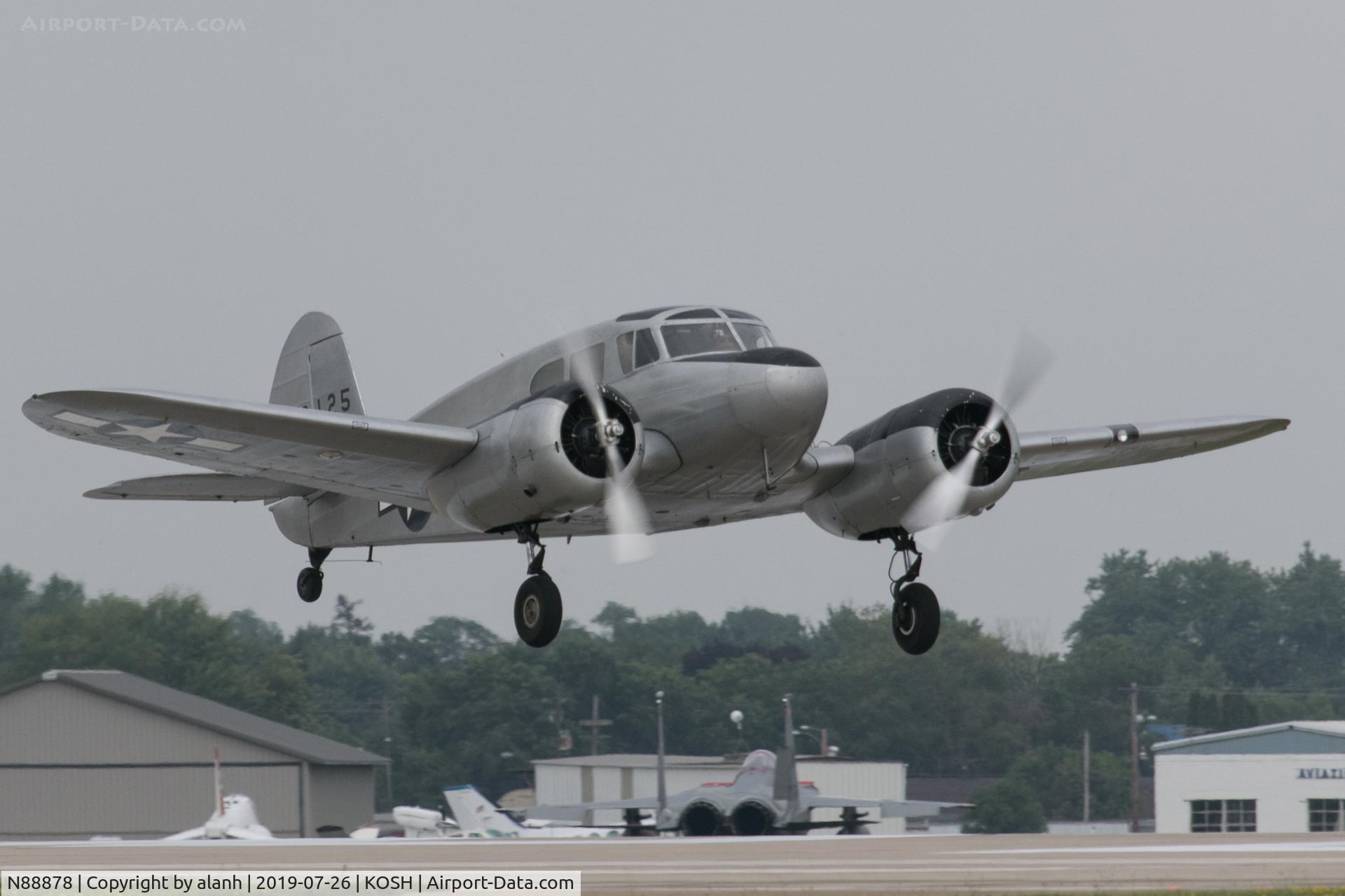 N88878, 1943 Cessna UC-78C (T-50) Bobcat C/N 4121, Taking off to display on a rare grey day at AirVenture 2019. This picture dedicated to my late friend Geoff Jones whose third attempt to photograph this aircraft air-to-air was foiled by reluctant engines.