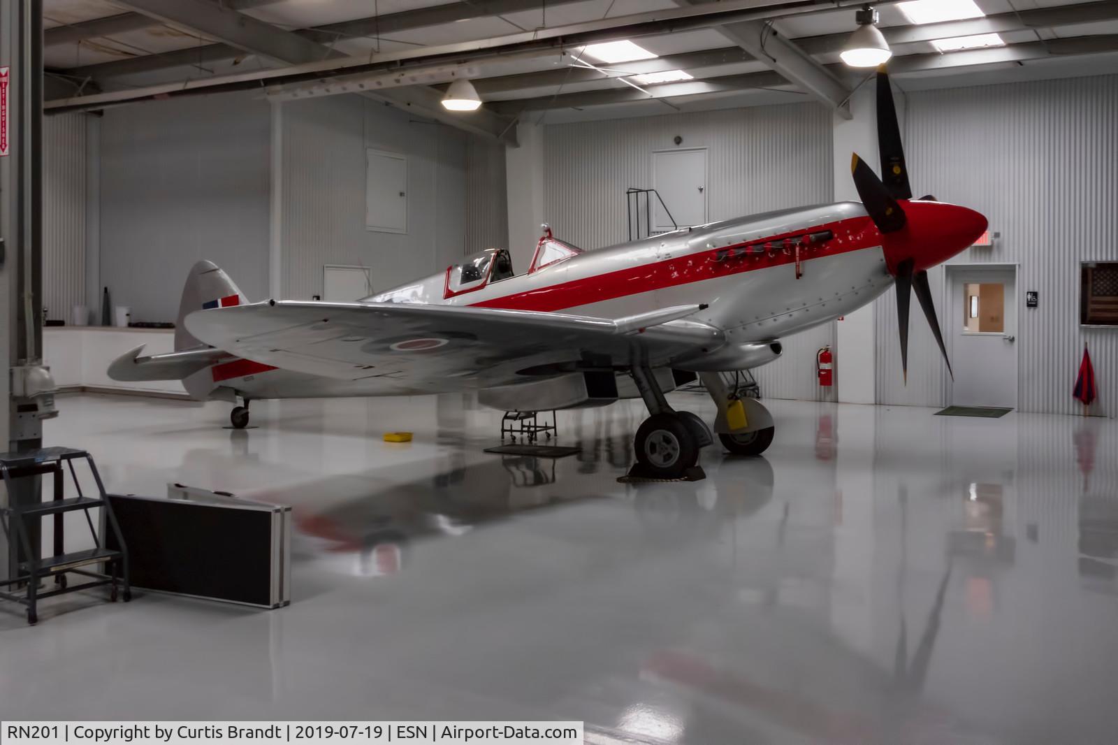 RN201, 1945 Supermarine 361 Spitfire F.XIVe C/N 6S/663417, Sold in July of 2019 . currently in the UK being managed at an airfield North of Cambridge . believe by Richard Grace . owned by someone in Australia .   Photo taken in the Spitfire Hanger in Easton, Md-packing 
photos on website under Spitfire Hanger