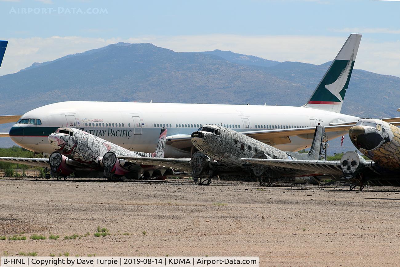 B-HNL, 1994 Boeing 777-267 C/N 27116, Located at Pima Air & Space Museum, adjacent to KDMA. 12 June 1994: At 11:45 a.m., the first Boeing 777-200 airliner, line number WA001, registration N7771, made its first flight. This is that plane. It now lives next to some strange creatures.