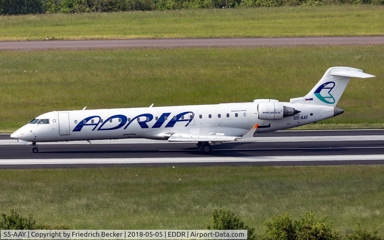 S5-AAY, 2003 Bombardier CRJ-701ER (CL-600-2C10) Regional Jet C/N 10080, decelerating after touchdown inbound from TXL