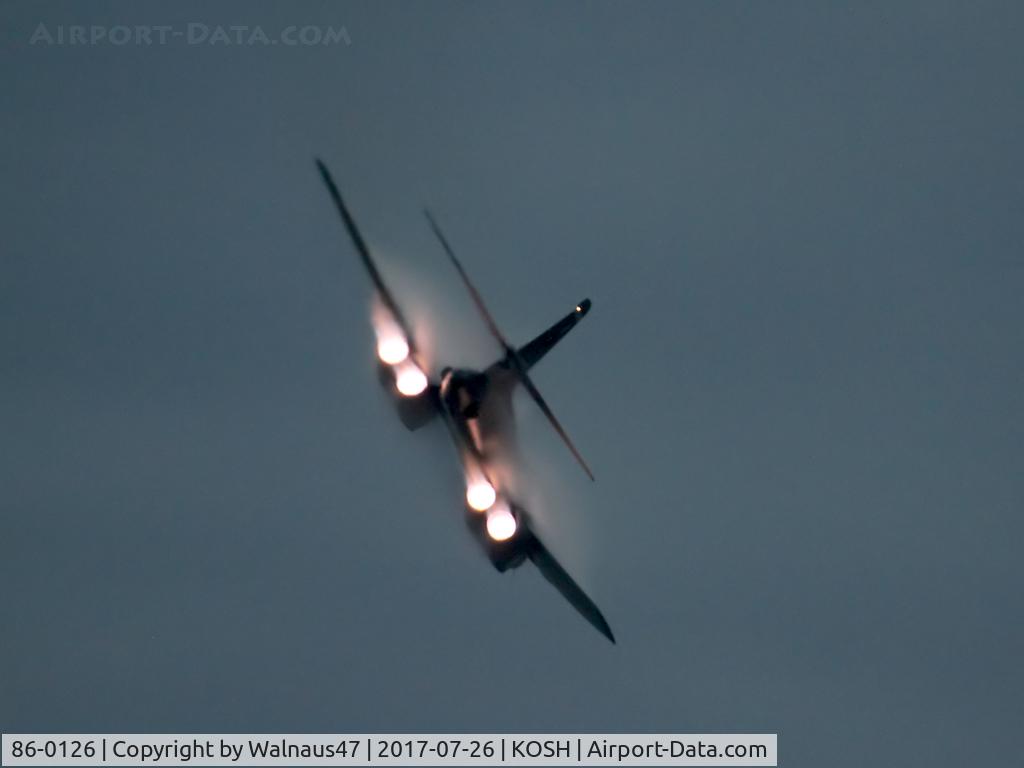 86-0126, 1986 Rockwell B-1B Lancer C/N 86, Low res – hard to catch after dark - Rear view of USAF B-1B AF 86-0126 Cn 86 departing after a Dusk ‘ Afterburner Vapour Run’, with wings partly swept rearward. Photo taken at 1931 hrs at the start of the Night Airshow, at Air Venture Oshkosh on 26Jul2017