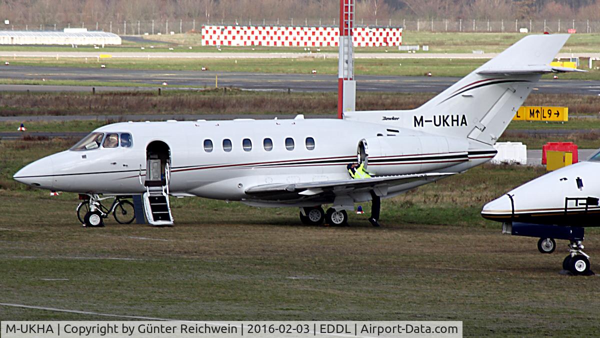 M-UKHA, 2003 Raytheon Hawker 800XP C/N 258625, Note the athletic mechanic and his bike leaned to the front gear