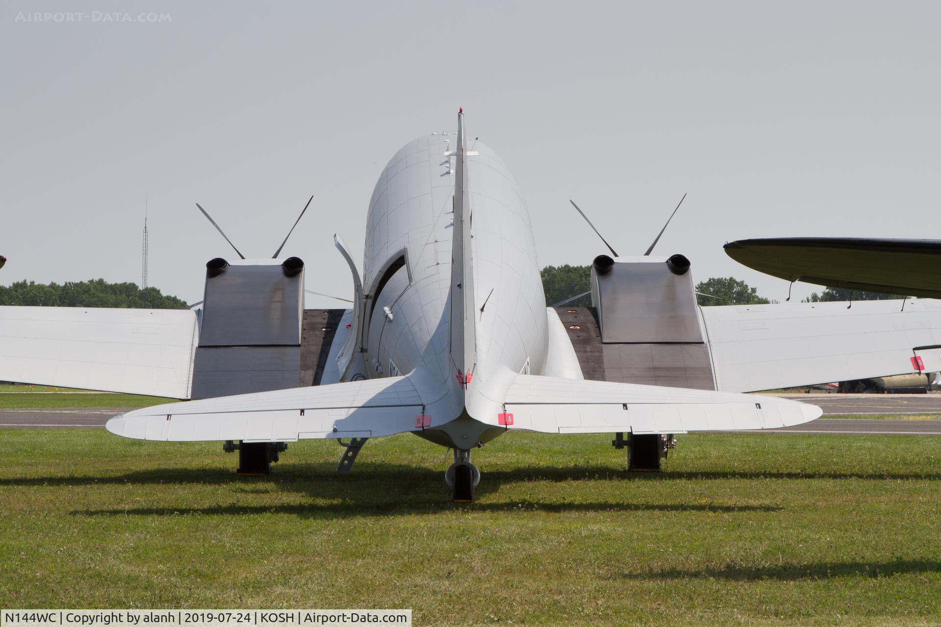 N144WC, 1944 Douglas DC-3C C/N 32843, Parked in the warbirds area at AirVenture 2019. The rear view shows the remodelled nacelles with twin exhausts from the PW Canada turboprops.