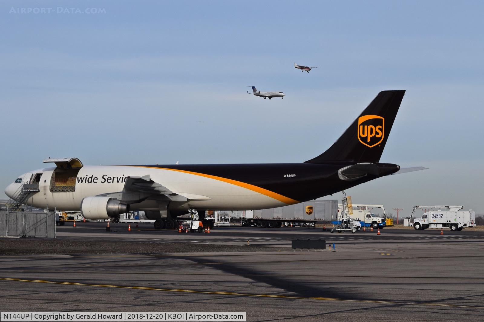 N144UP, 2002 Airbus A300F4-622R C/N 827, Loading on the UPS ramp and landing aircraft for 10L and 10R.