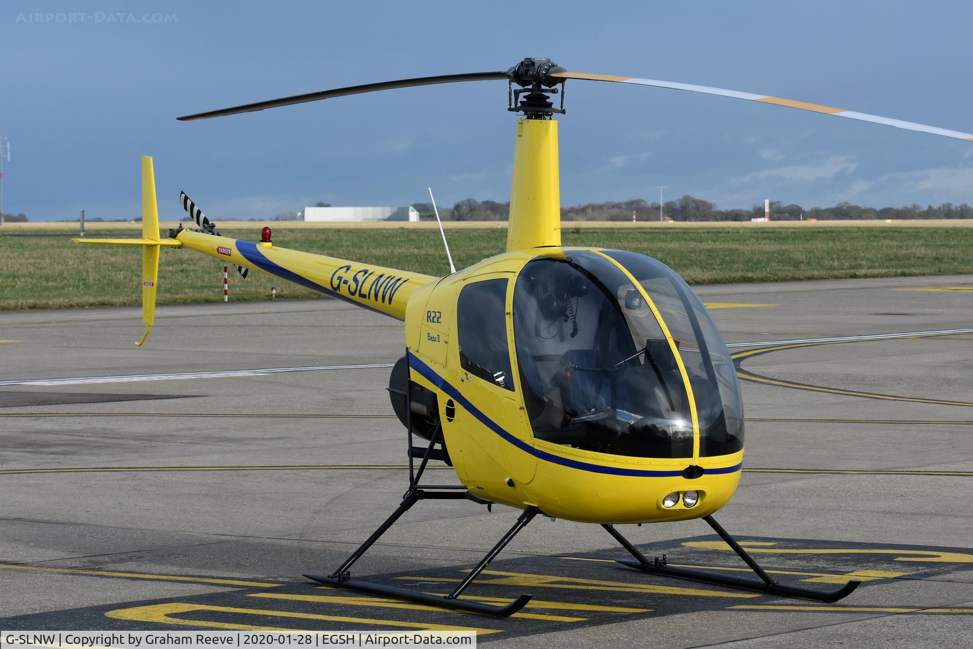 G-SLNW, 2003 Robinson R22 Beta II C/N 3524, Parked at Norwich.