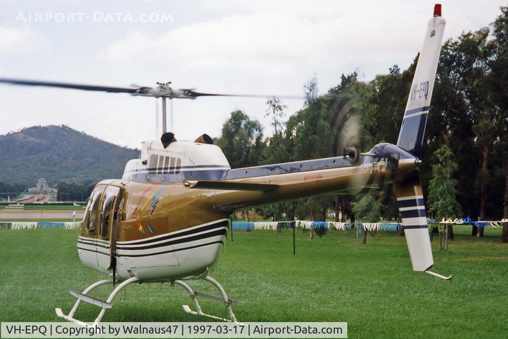 VH-EPQ, 1970 Bell 206B-2 JetRanger II C/N 219, Rear Port side view of Private Bell 206B JetRanger II VH-EPQ Cn 219 (with rotors turning) on a temporary grass helipad near Old Parliament House, Canberra, during Canberra Week festivities on 17Mar1997. Mt Ainslie and the AWM are visible at left.