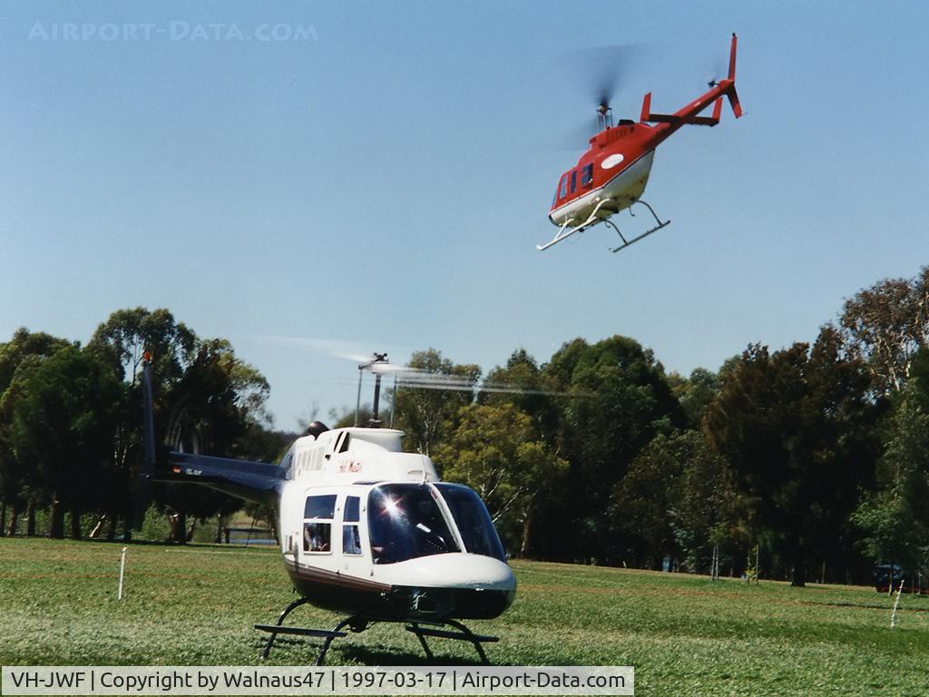 VH-JWF, 1981 Bell 206B-3 JetRanger III C/N 3421, Front Stbd view of Bell 206 VH-JWF Cn 3421 on the grass near Lake Burley Griffin Canberra during Canberra Week festivities on 17Mar1997 (Canberra Day). Bell 206L-3 LongRanger III VH-SBC is departing at rear.