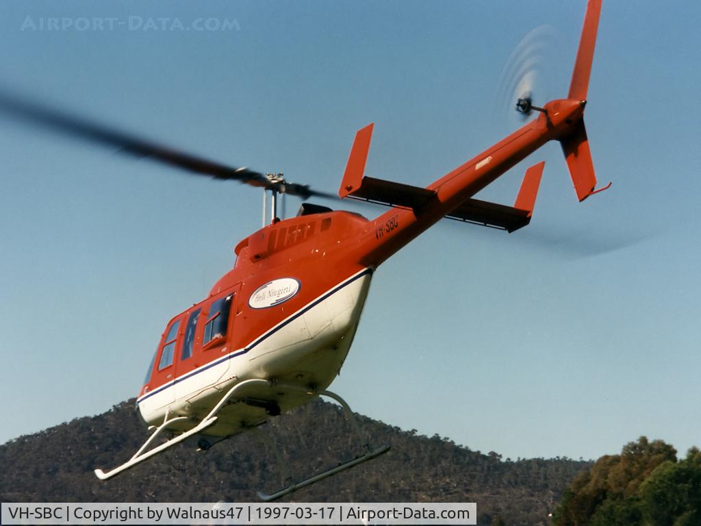 VH-SBC, 1973 Bell 206L-3 LongRanger III LongRanger III C/N 51396, Rear Port side view of Bell 206L-3 LongRanger III VH-SBC Cn 51396 departing towards Lake Burley Griffin Canberra during Canberra Week festivities on 17Mar1997-Canberra Day. Mt Ainslie is at rear. Several Bell JetRangers flew many 5 min joyflights that day
