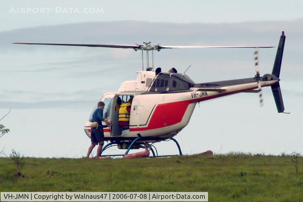 VH-JMN, 1974 Bell 206B JetRanger II C/N 1353, Rear Port side view of Bell 206B JetRanger II VH-JMN Cn 1353 on a hillside near Cairns befor departing to a pontoon on the Great Barrier Reef QLD on 08Jul2006. The helo is fitted with ‘pop-out floats’ for over-water operations.