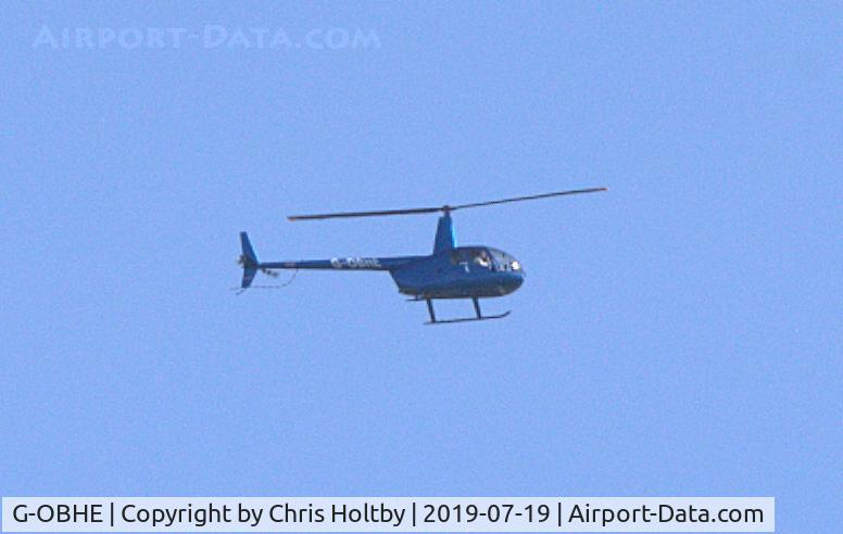 G-OBHE, 1997 Robinson R44 Astro C/N 0381, Out of Elstree flying over Potters Bar (distantly)