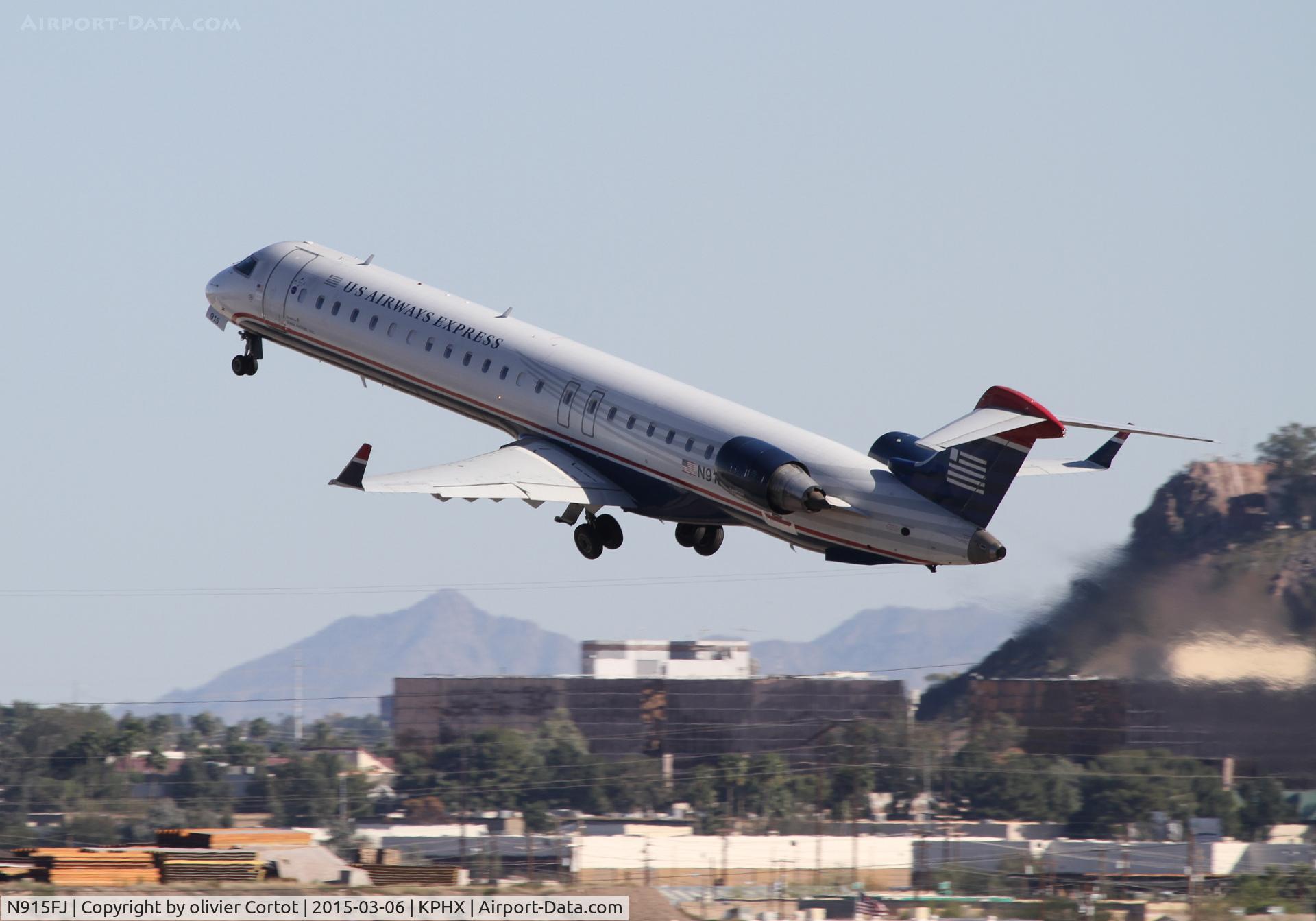 N915FJ, 2004 Bombardier CRJ900 (CL-600-2D24) C/N 15015, leaving Phoenix