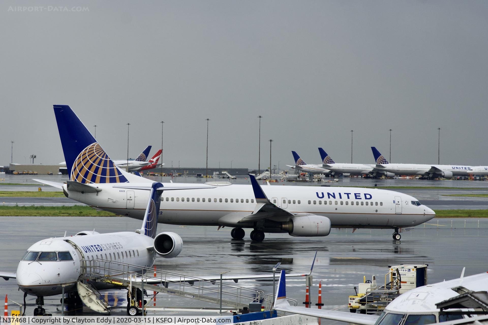 N37468, 2013 Boeing 737-924/ER C/N 32836, Rainy morning Coronavirus parking far side of picture. SFO 2020.