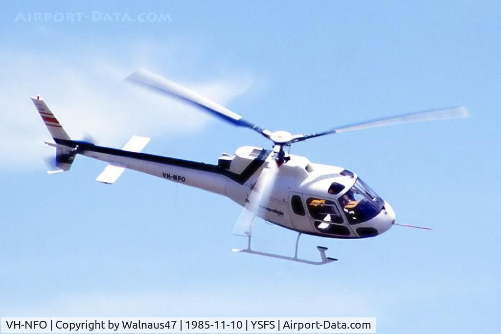 VH-NFO, 1985 Eurocopter AS-350B Ecureuil Ecureuil C/N 1823, Topside view of New AS-350B2 helicopter VH-NFO Cn 1823 flying at the Schofields Air Show (held at HMAS Nirimba YSFS) on 10Nov1985. (This helo was First Registered on 09Oct1985.) The 'Starflex' rotor hub has more manoeuverability than teetering rotors.