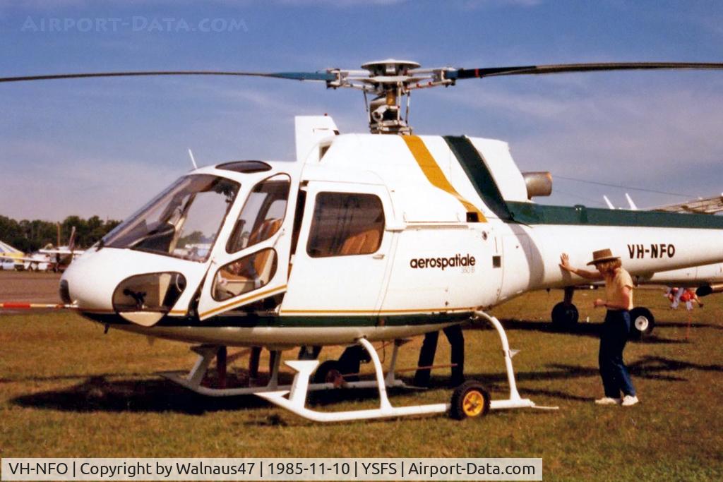 VH-NFO, 1985 Eurocopter AS-350B Ecureuil Ecureuil C/N 1823, Port side front end of New AS-350B helicopter VH-NFO Cn 1823, being closely inspected while on static display at the Schofields Air Show (held at HMAS Nirimba) on 10Nov1985. (This helo was First Registered in Australia on 09Oct1985.)