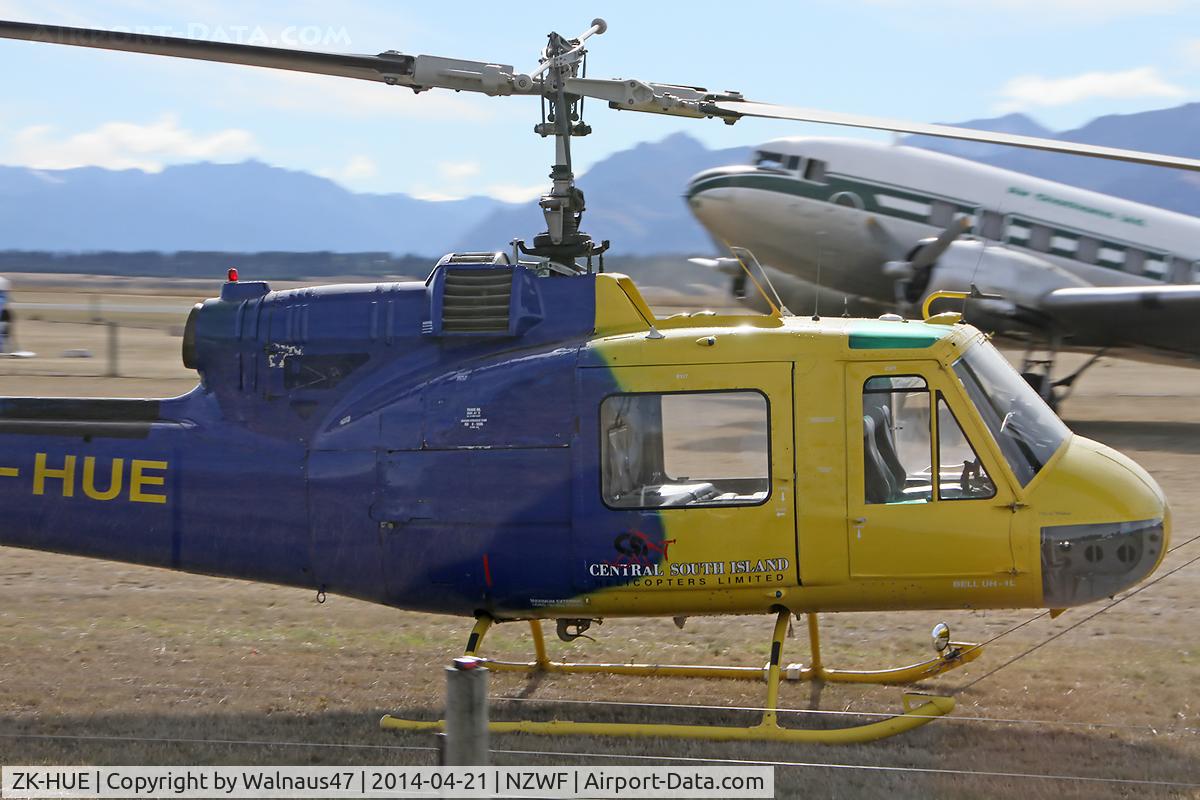 ZK-HUE, Bell UH-1E Iroquois C/N 6045, Stdb side view of the front end of Bell UH-1E ZK-HUE Cn 6045 at Wanaka NZWF on 21Apr2014, during Warbirds Over Wanaka (WOW) 2014. ZK-HUE wears a distinctive Blue/Yellow livery, for sponsor: ‘NZ Automobile Association’.