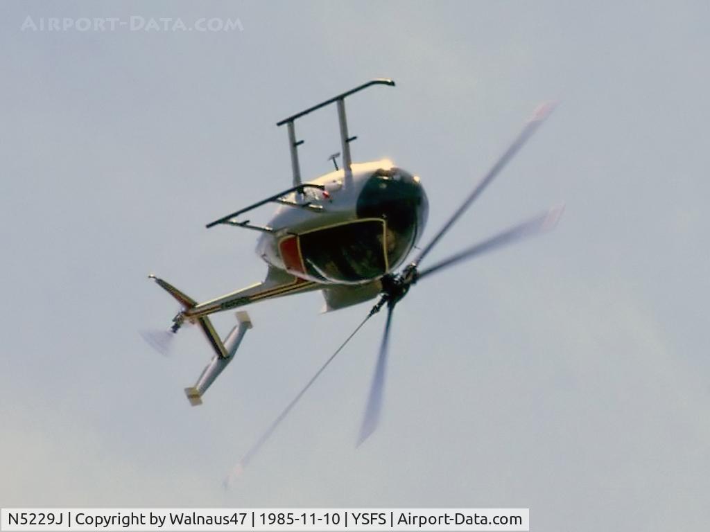 N5229J, Hughes 369E C/N 0148E, Hughes 369E / 500E N5229J Cn 0148E rolling inverted at the Schofields Airshow at YSFS on 10Nov1985. (An unusual helicopter manoeuvre, even today!) The USA Registered helo was then being operated for U.A.A. Films Limited in Sydney.
