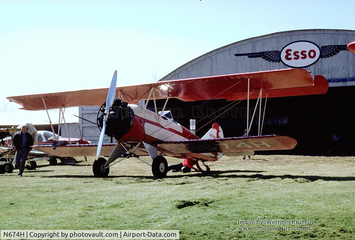 N674H, 1929 Curtiss-Wright Travel Air 2000 C/N 1219, N674H stands in front of an Esso flying wings Hangar.