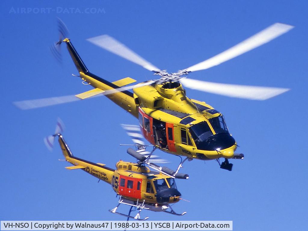 VH-NSO, 1998 Schempp-Hirth Discus 2b C/N 8, Topside view of two NSCA Helicopters (in High-Vis Yellow livery) at the 1988 (Bi-Centennial) Canberra Air Pageant on 13Mar1988. Bell 412 VH-NSO Code 11 (front), and Bell 205A-1 VH-NSM Code 05 is equipped with a water tank and filler hose for fire-fighting