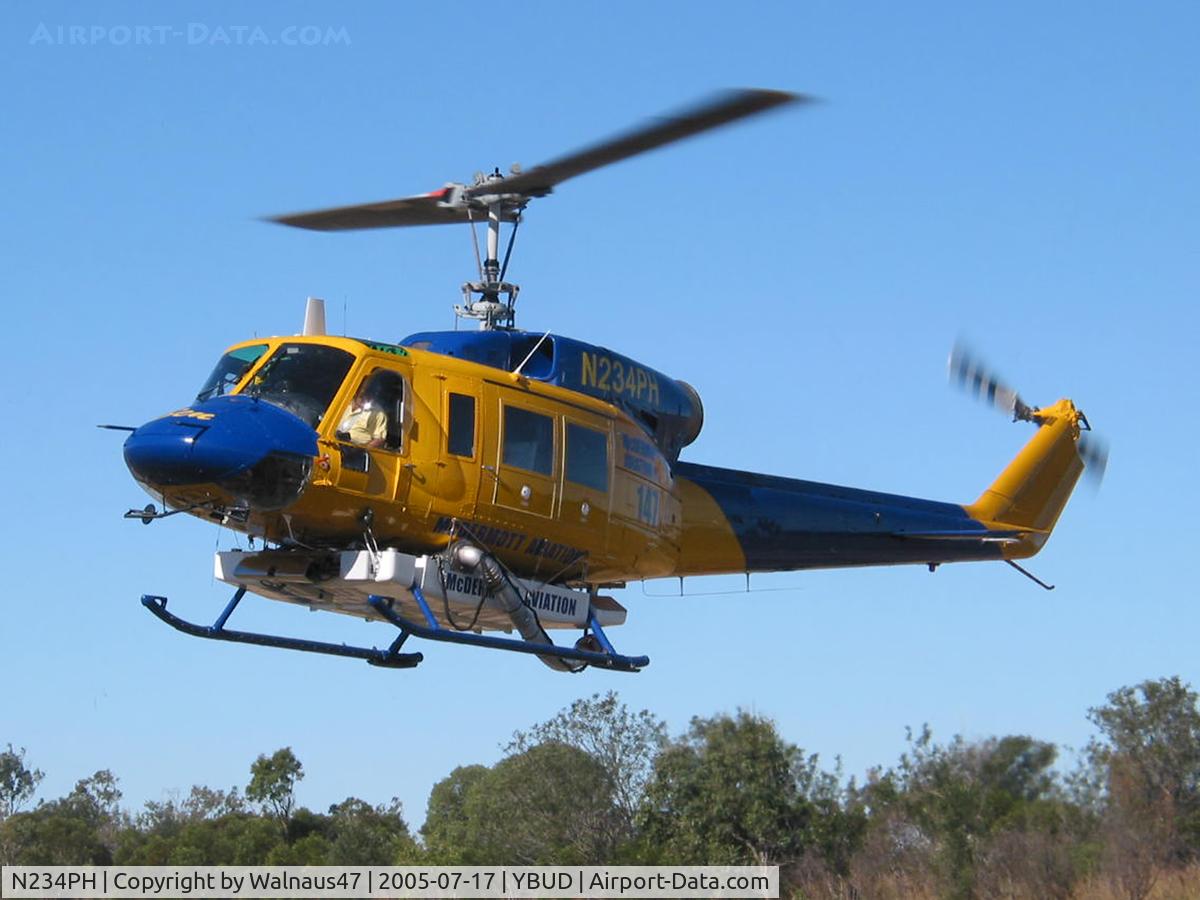 N234PH, 1977 Bell 214B-1 Biglifter C/N 28050, Front Portside view of McDermott Aviation Bell 214B-1 Biglifter N234PH Cn 28050 hovering at Bundaberg Airshow at Bundaberg Airport YBUD on 17Jul2005. Equipped with ‘under-cabin’ water tank. The operator was based at Cooroy QLD.