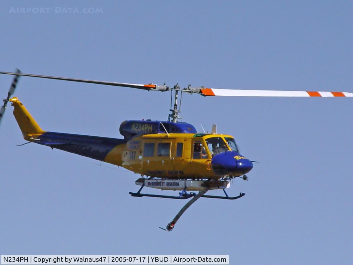 N234PH, 1977 Bell 214B-1 Biglifter C/N 28050, Front Stbd view of McDermott Aviation Bell 214B-1 Biglifter N234PH Cn 28050 flypast at Bundaberg Airshow at Bundaberg Airport YBUD on 17Jul2005. Equipped with ‘under-cabin’ water tank, with ‘pick-up’ hose extended.