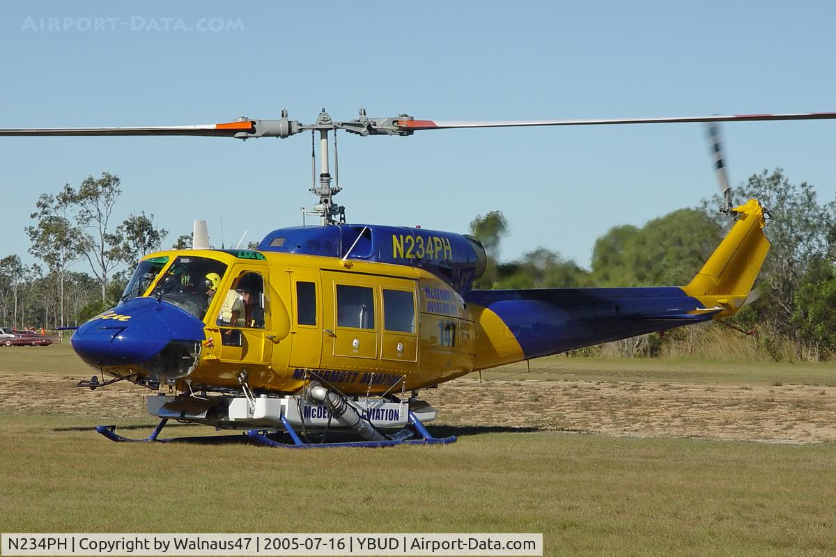 N234PH, 1977 Bell 214B-1 Biglifter C/N 28050, Close cropped Front Portside view of McDermott Aviation Bell 214B-1 Biglifter N234PH Cn 28050 parked at Bundaberg Airshow at Bundaberg Airport YBUD on 16Jul2005. Equipped with ‘under-cabin’ water tank, with ‘pick-up’ hose retracted.