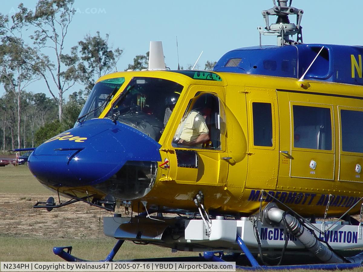 N234PH, 1977 Bell 214B-1 Biglifter C/N 28050, Close cropped Front Portside view of cabin of McDermott Aviation Bell 214B-1 Biglifter N234PH Cn 28050 parked at Bundaberg Airshow at Bundaberg Airport YBUD on 16Jul2005. Equipped with ‘under-cabin’ water tank, and ‘pick-up’ hose.