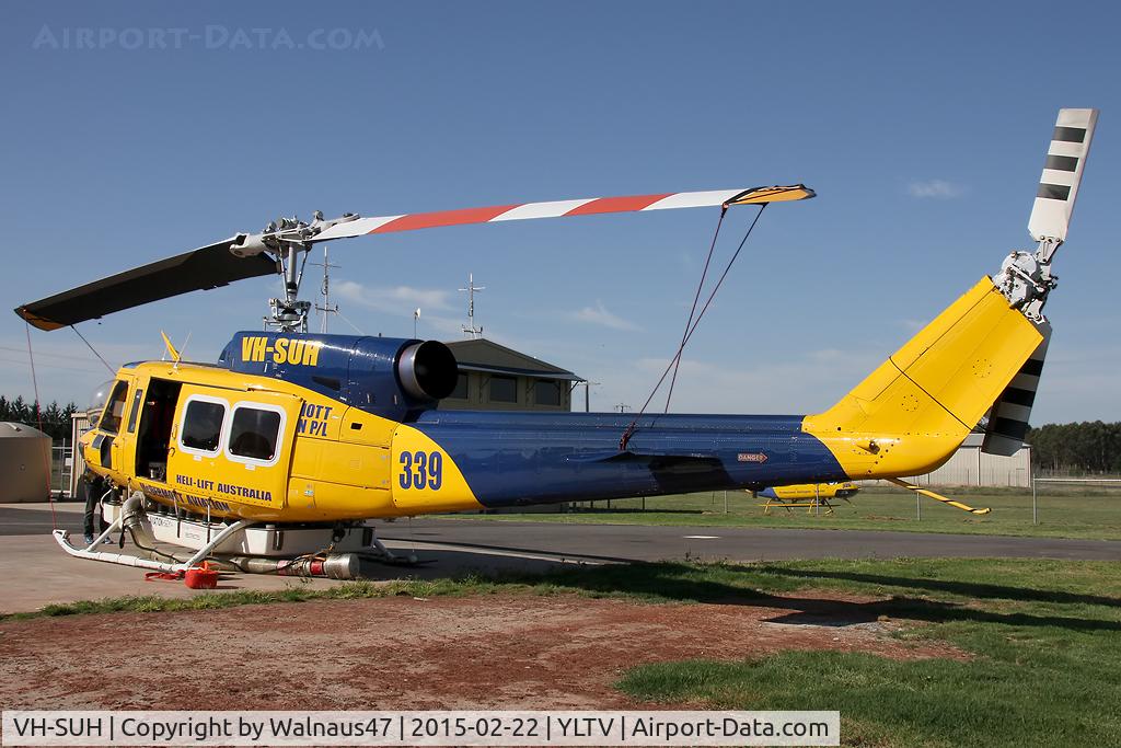 VH-SUH, 1976 Bell 214B-1 Biglifter Biglifter C/N 28017, Rear Portside view of McDermott Aviation Bell 214B-1 VH-SUH Cn 28017 HeliTack 339, taken at Latrobe Valley Airport (YLTV) Morwell on 22Feb2015. Fitted with a ‘HeliLift’ water/ fire retardant tank under the cabin.