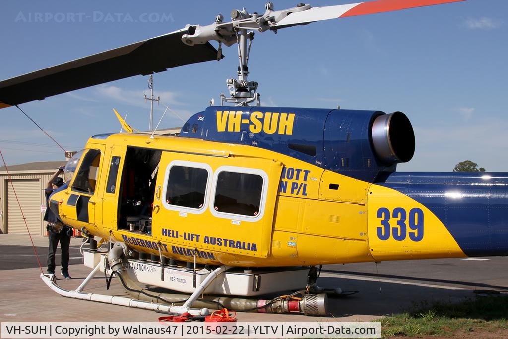 VH-SUH, 1976 Bell 214B-1 Biglifter Biglifter C/N 28017, Rear Portside view of cabin of McDermott Aviation Bell 214B-1 VH-SUH Cn 28017 HeliTack 339, at Latrobe Valley Airport (YLTV) Morwell on 22Feb2015. Fitted with a ‘HeliLift’ water/ fire retardant tank under the cabin.