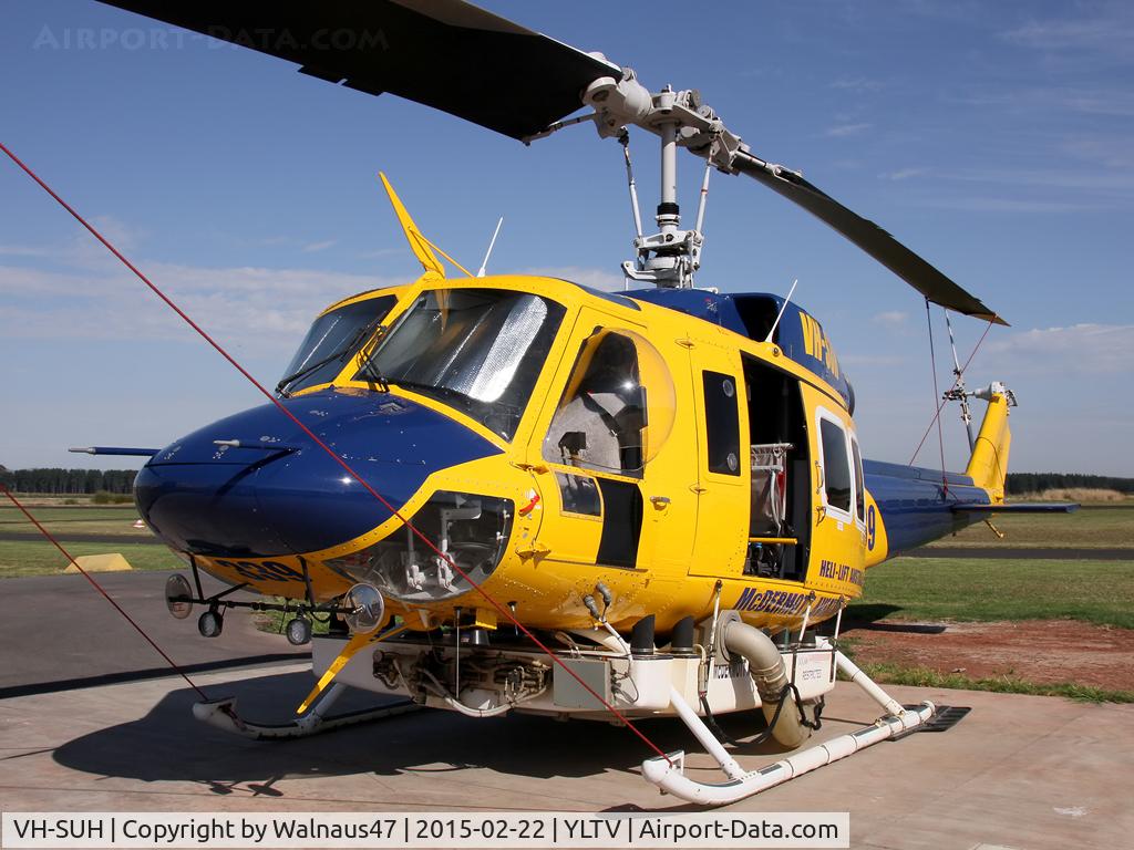 VH-SUH, 1976 Bell 214B-1 Biglifter Biglifter C/N 28017, Close-cropped Front Portside view of cabin of McDermott Aviation Bell 214B-1 VH-SUH Cn 28017 HeliTack 339, at Latrobe Valley Airport (YLTV) Morwell on 22Feb2015. Fitted with a ‘HeliLift’ water/ fire retardant tank under the cabin.