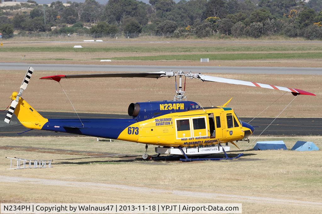 N234PH, 1977 Bell 214B-1 Biglifter C/N 28050, Stbd view of McDermott Aviation Bell 214B-1 Biglifter N234PH Cn 28050 parked at Jandakot Airport YPJT West Australia on 18Nov2013. Equipped with ‘under-cabin’ water tank, with ‘pick-up’ hose, wearing Code Helitack 673.