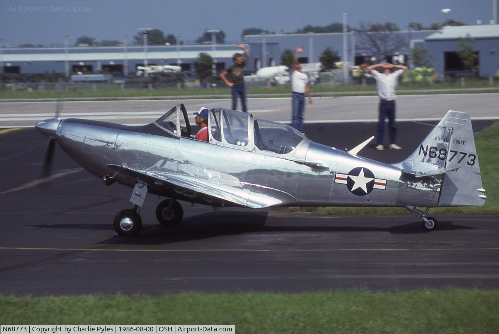 N68773, 1950 Temco T-35 Buckaroo (TE-1B) C/N 6008, Typical Oshkosh. A rare airplane taxiies by and nobody sees it, but almost everything thing is rare including whatever those guys are watching overhead.
