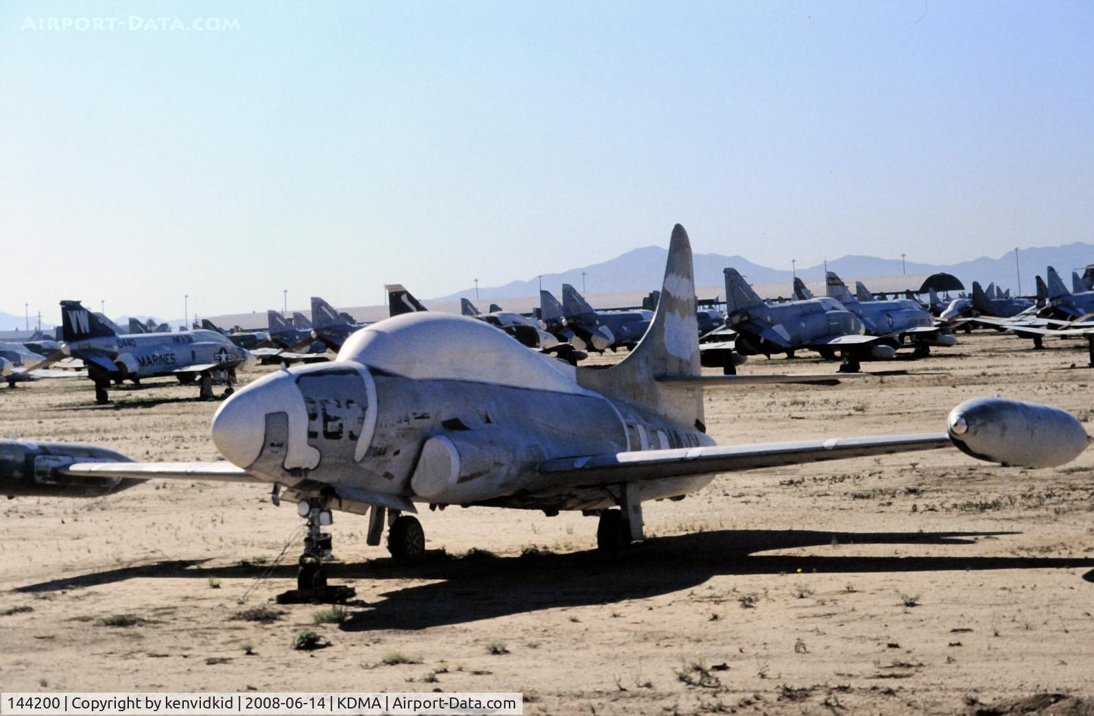 144200, 1957 Lockheed T-1A Seastar C/N 1080-1104, At Davis Monthan from an air-conditioned bus, circa 1996.