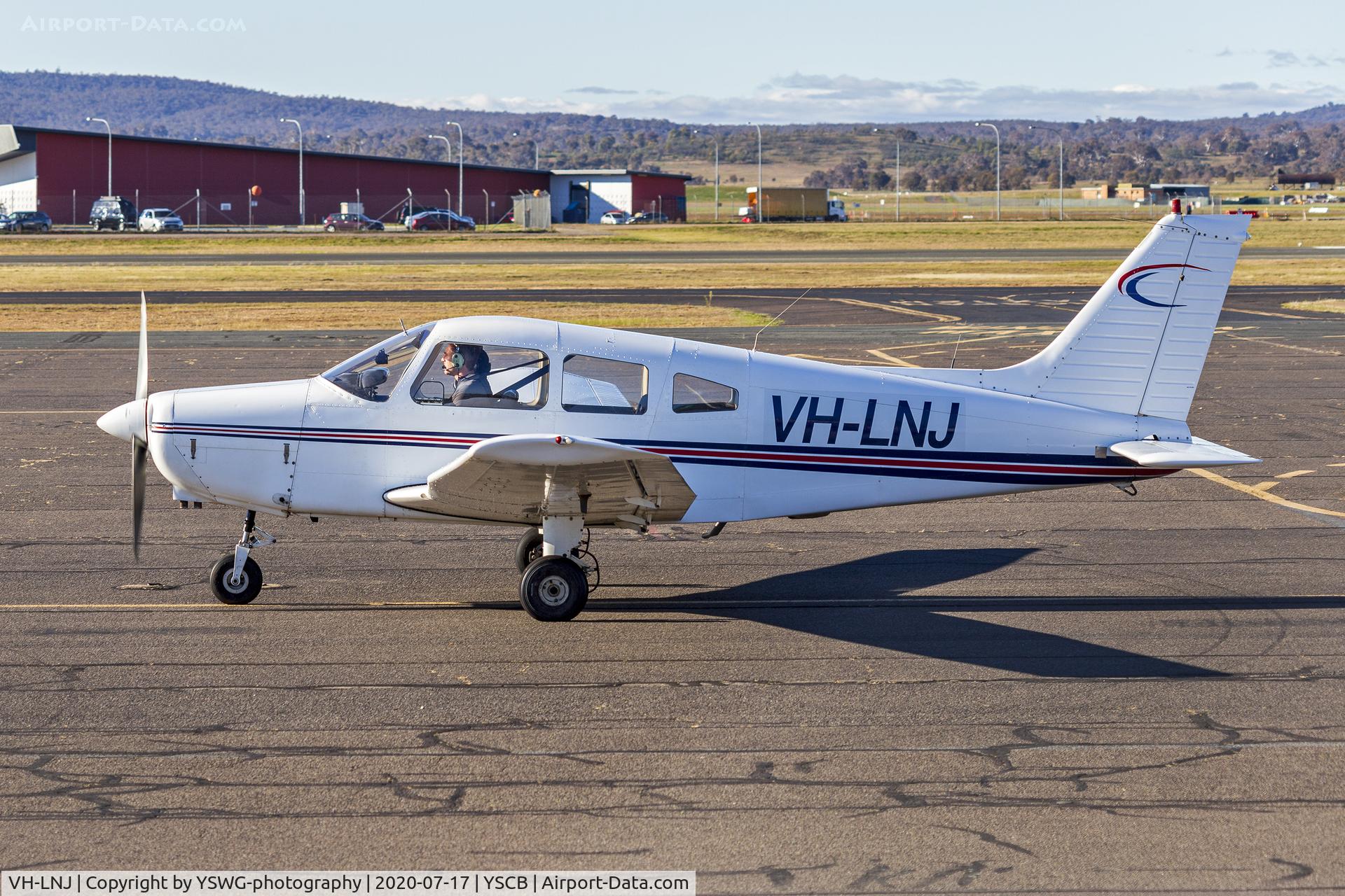 VH-LNJ, 1977 Piper PA-28-151 Cherokee Warrior C/N 28-7715154, Meehan Traders (VH-LNJ) Piper PA-28-151 Cherokee Warrior taxiing at Canberra Airport.