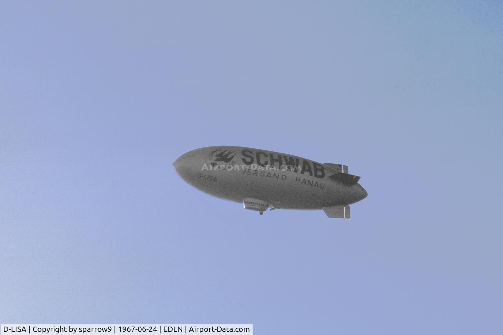 D-LISA, 1942 Goodyear L-class C/N L0019, Overhead Moenchengladbach aerodrome.Scanned from a slide, cropped. http://landewers.net/L-19.pdf