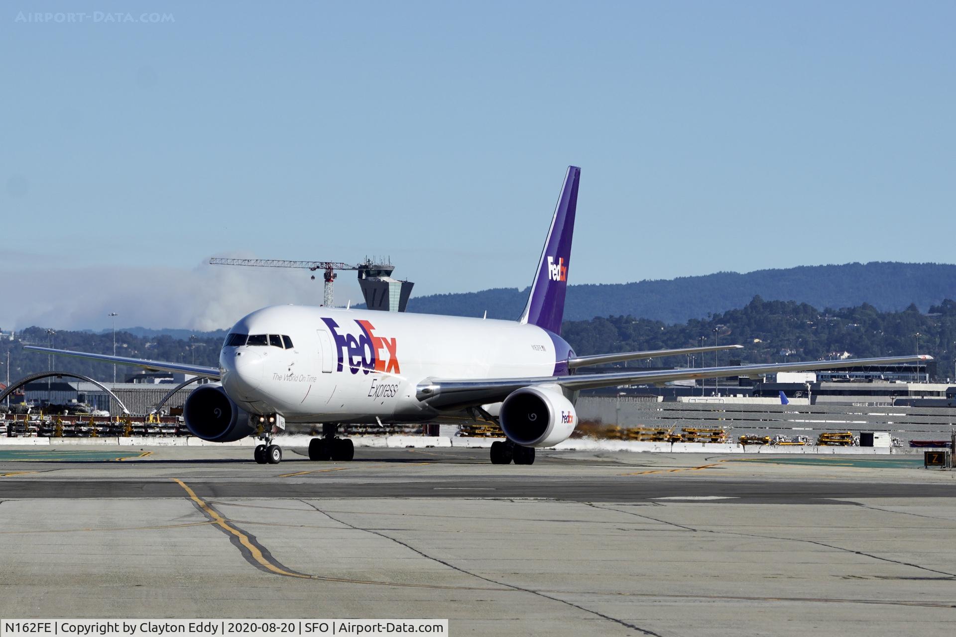N162FE, 2018 Boeing 767-3S2F(ER) C/N 43632, You can see smoke from the Santa Cruz fire behind the aircraft. SFO 2020.